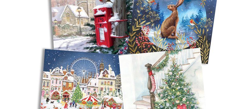 A selection of festive cards layed out on a white background.