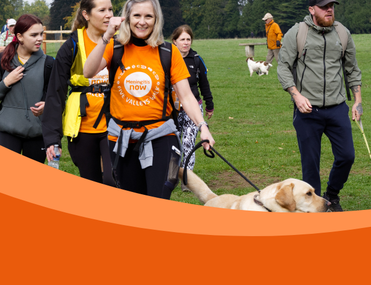 Group of walkers with dogs and front woman wearing Meningitis Now t-shirt