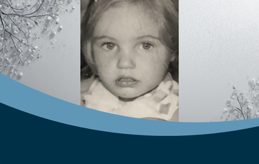 Black and white photo of a close up of a little girl with blonde hair