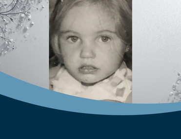 Black and white photo of a close up of a little girl with blonde hair