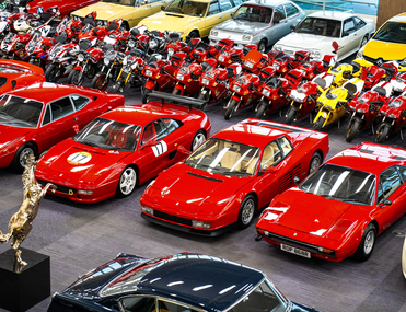Rows of red classic cars and motorbikes