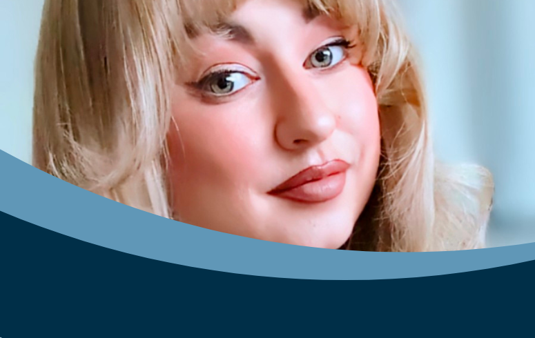 White woman with blonde hair in close up photo looking directly at camera