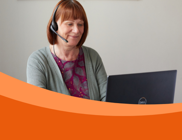 A woman with a headset smiles while using a Dell laptop, conveying a warm, professional tone. An orange wave design frames the bottom of the image.