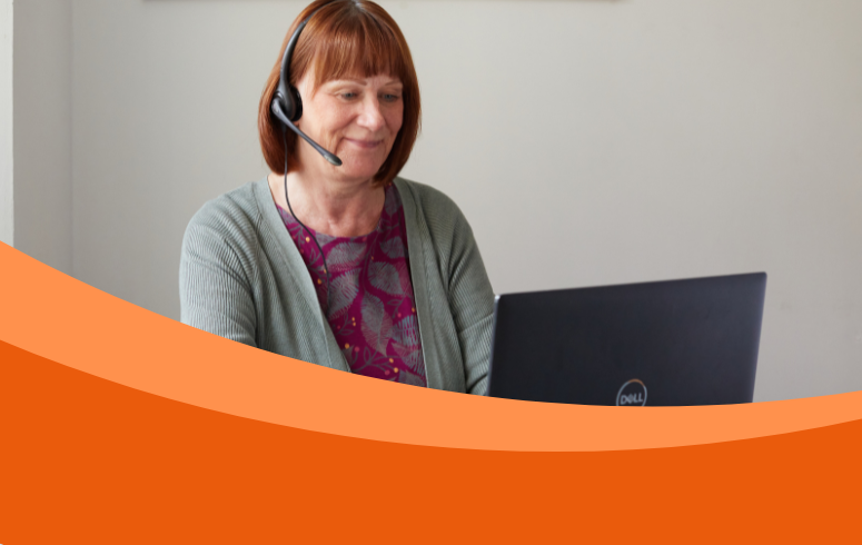 A woman with a headset smiles while using a Dell laptop, conveying a warm, professional tone. An orange wave design frames the bottom of the image.